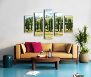 A living room with a brown sofa with throw pillows, a wooden coffee table in front, sitting on a blue floor. On the plain wall behind is a five panel split print featuring an image of cypress trees in Italy.