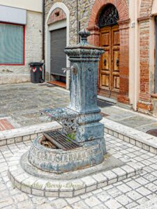 ornate drinking water fountains in Italy, this one is set in a residential courtyard