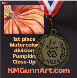 A composite picture featuring a section of a painting of an orange pumpkin, a 1st place 2022 medal with a red white and blue ribbon and the words 1st place watercolor division pumpkin close-up KMGunnArt.com