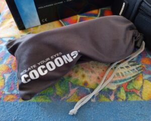 Eye glasses in a grey pouch with the word Cocoons